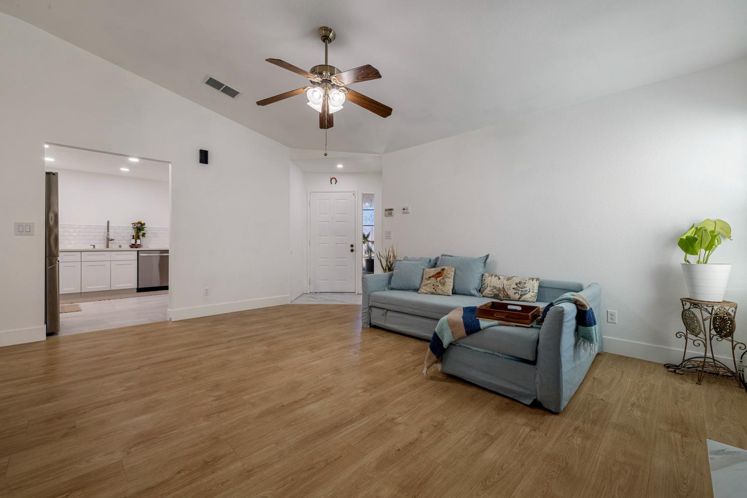 9488 Dunkerrin Way Elk Grove, CA 95758 - Photo 11 of 43 a living room with furniture and a chandelier