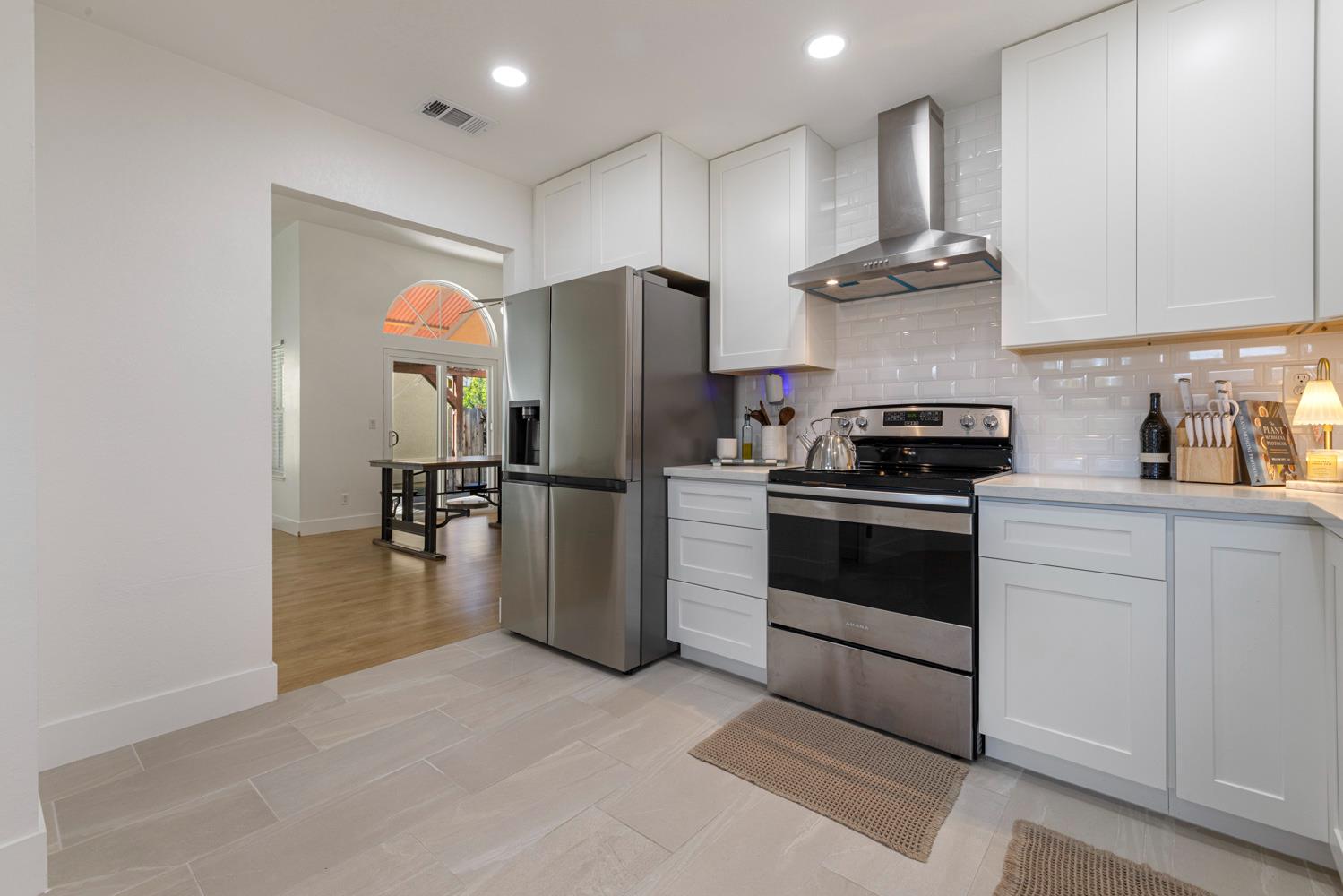 9488 Dunkerrin Way Elk Grove, CA 95758 - Photo 14 of 43 a kitchen with stainless steel appliances a refrigerator stove and microwave