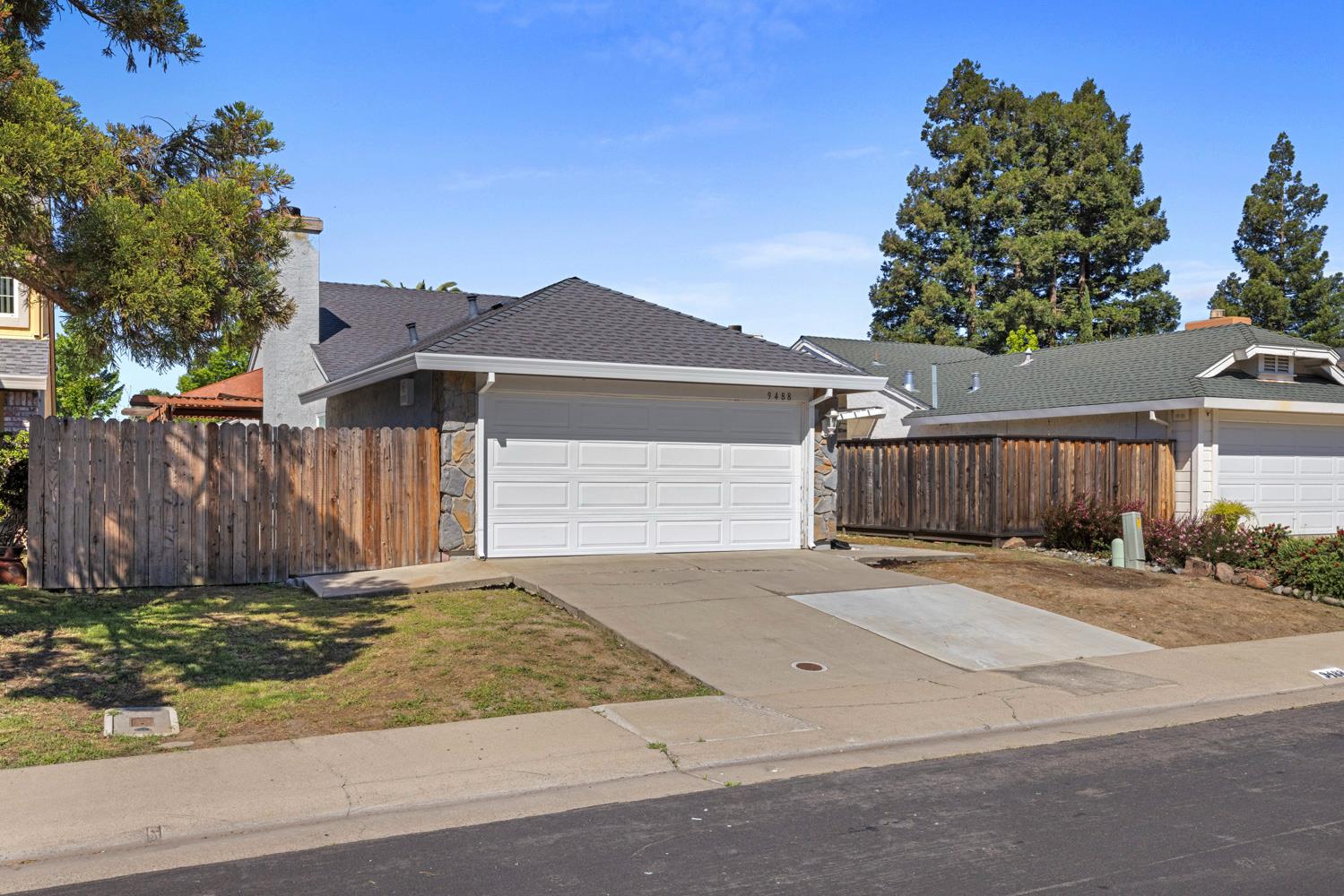 9488 Dunkerrin Way Elk Grove, CA 95758 - Photo 2 of 43 a front view of a house with a yard and garage