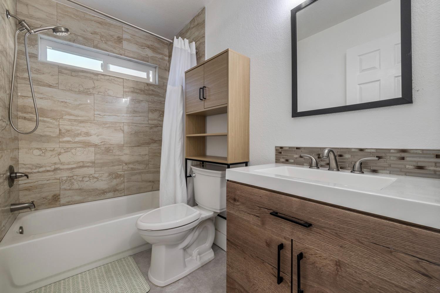 9488 Dunkerrin Way Elk Grove, CA 95758 - Photo 30 of 43 a bathroom with a sink toilet tub and shower