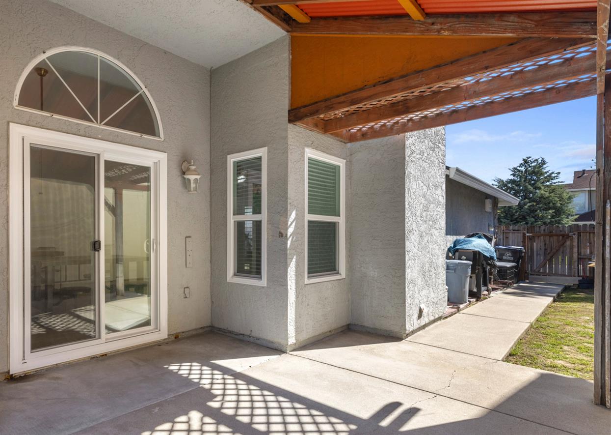 9488 Dunkerrin Way Elk Grove, CA 95758 - Photo 33 of 43 a view of a porch with furniture and floor to ceiling window