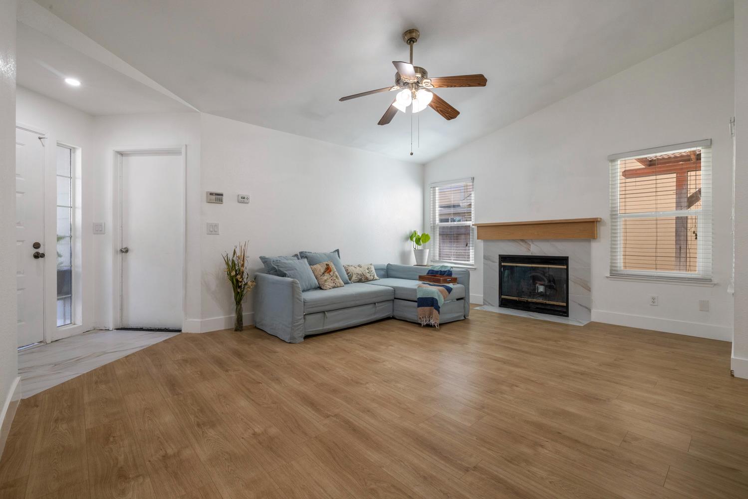 9488 Dunkerrin Way Elk Grove, CA 95758 - Photo 9 of 43 a living room with furniture and a fireplace