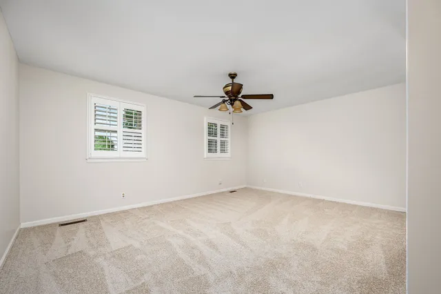 a view of a room with a ceiling fan