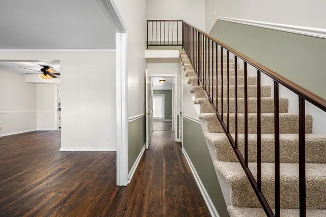 a view of a hallway view with wooden floor and staircase