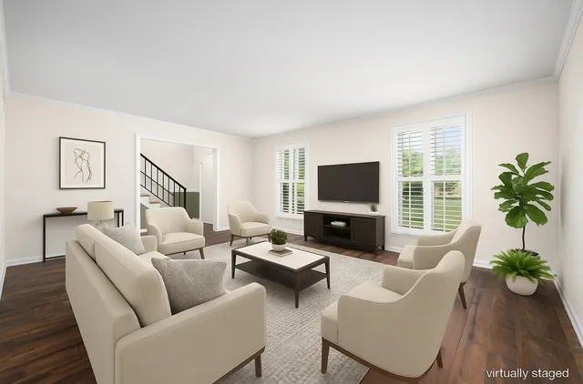 a living room with furniture a flat screen tv and a large window
