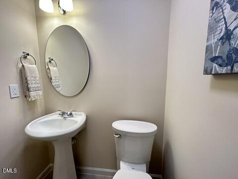 2510 Friedland Place, Unit 102 Raleigh, NC 27617 - Photo 18 of 42 a bathroom with a toilet sink and mirror