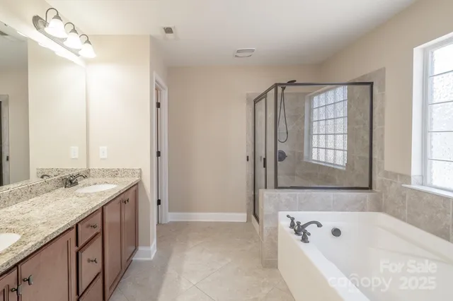 a bathroom with a tub sink and mirror