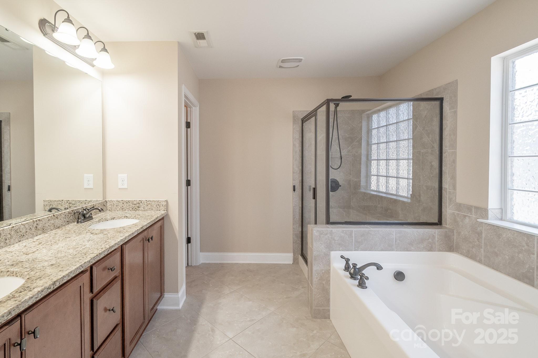 2003 Fallondale Road Waxhaw, NC 28173 - Photo 18 of 27 a bathroom with a tub sink and mirror