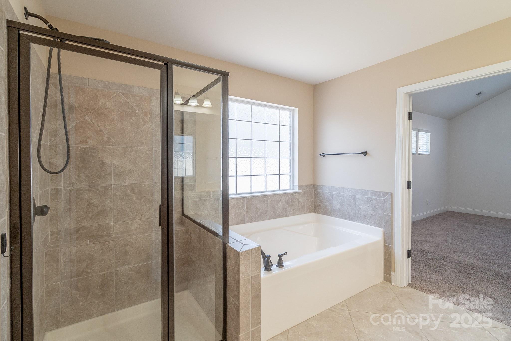 2003 Fallondale Road Waxhaw, NC 28173 - Photo 19 of 27 a bathroom with a bath tub and a shower