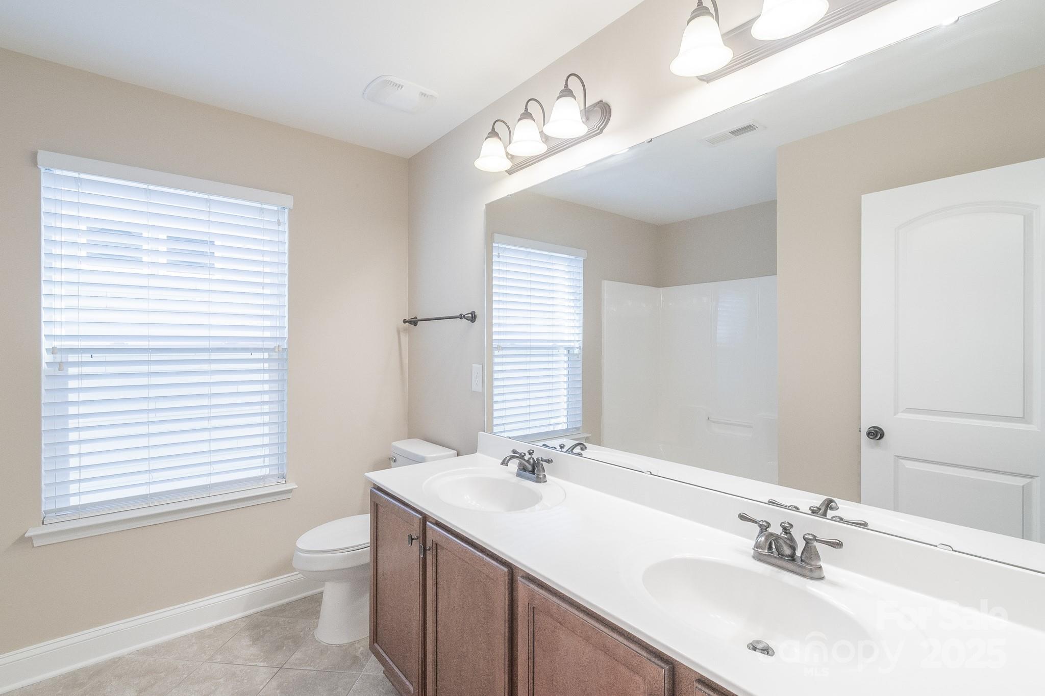 2003 Fallondale Road Waxhaw, NC 28173 - Photo 23 of 27 a bathroom with a sink double vanity and a toilet