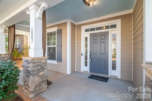 a view of an entryway with wooden floor and a livingroom view