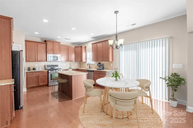 a large kitchen with a table and chairs