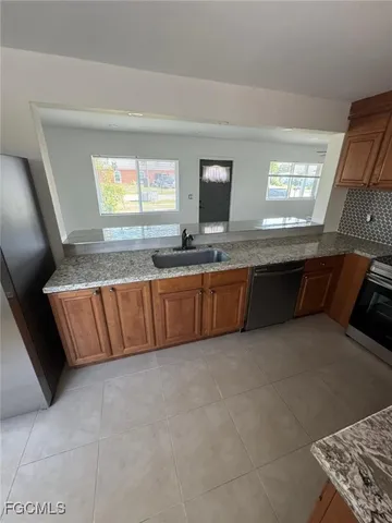 a kitchen with stainless steel appliances a refrigerator and a microwave