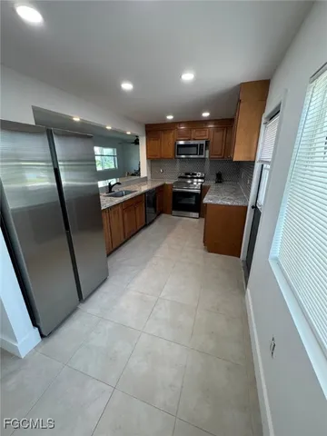 a kitchen with a table chairs microwave and cabinets