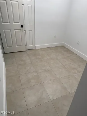 a backyard of a house with barbeque oven table and chairs