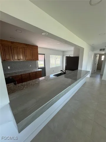 a bathroom with a sink and mirror with toilet