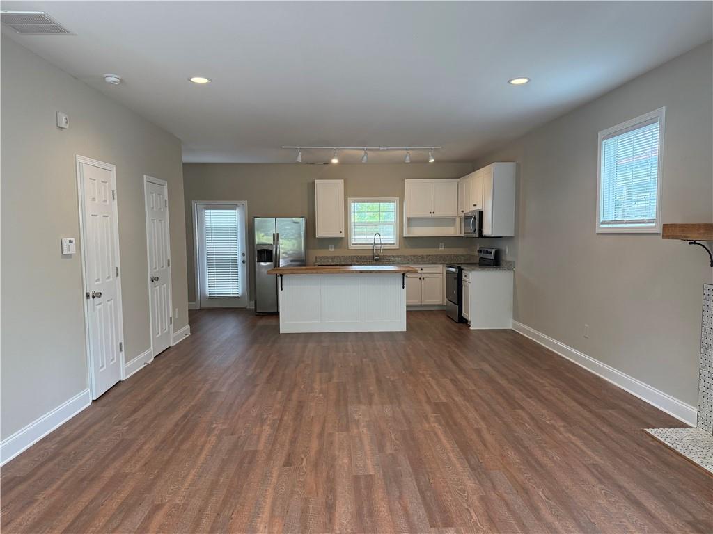 78 Liberty Court Gainesville, GA 30501 - Photo 5 of 13 a kitchen with stainless steel appliances granite countertop a refrigerator a sink dishwasher a stove and white countertops with wooden floor
