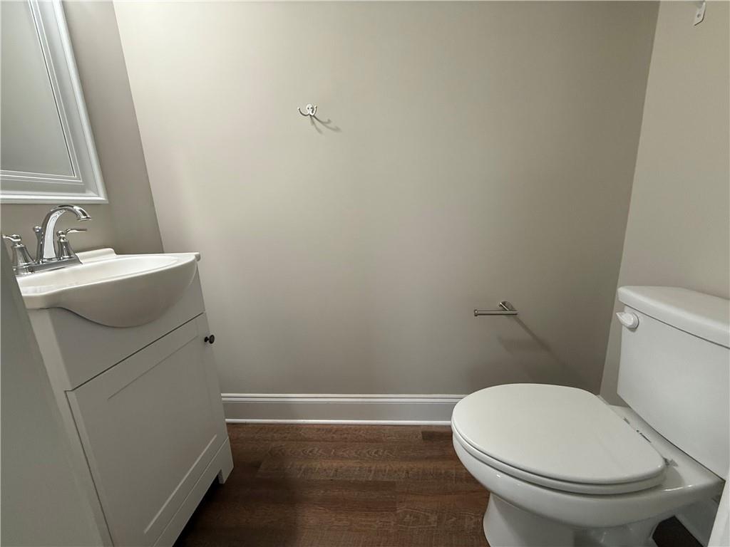 78 Liberty Court Gainesville, GA 30501 - Photo 8 of 13 a white toilet sitting next to a bathroom sink