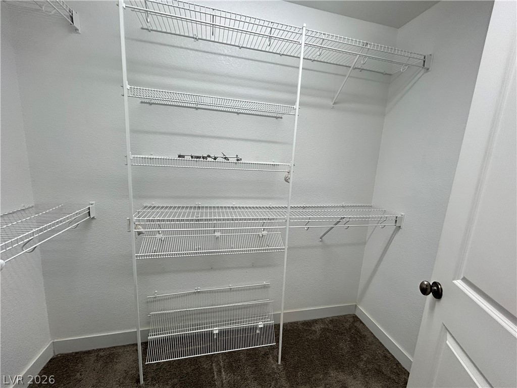 6538 Elm Spring Las Vegas, NV 89148 - Photo 11 of 29 Custom wire shelving provides ample organization for any wardrobe in this dedicated closet space.