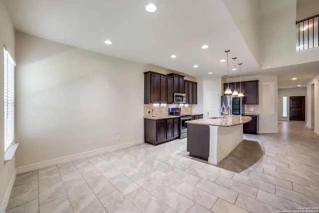 a kitchen with a refrigerator and a counter top space