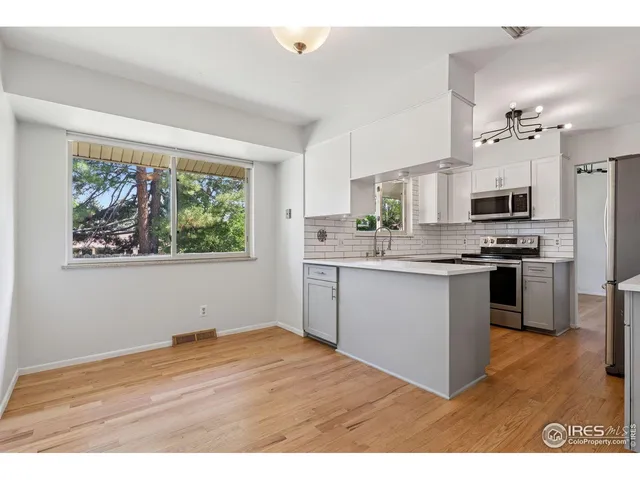a kitchen with stainless steel appliances a refrigerator sink and microwave