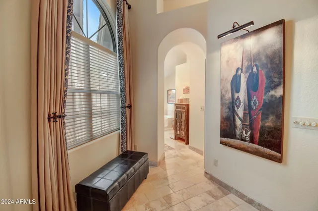 a living room with furniture a fireplace and a chandelier