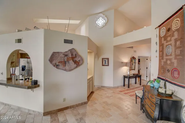 a living room with furniture a rug and a large window