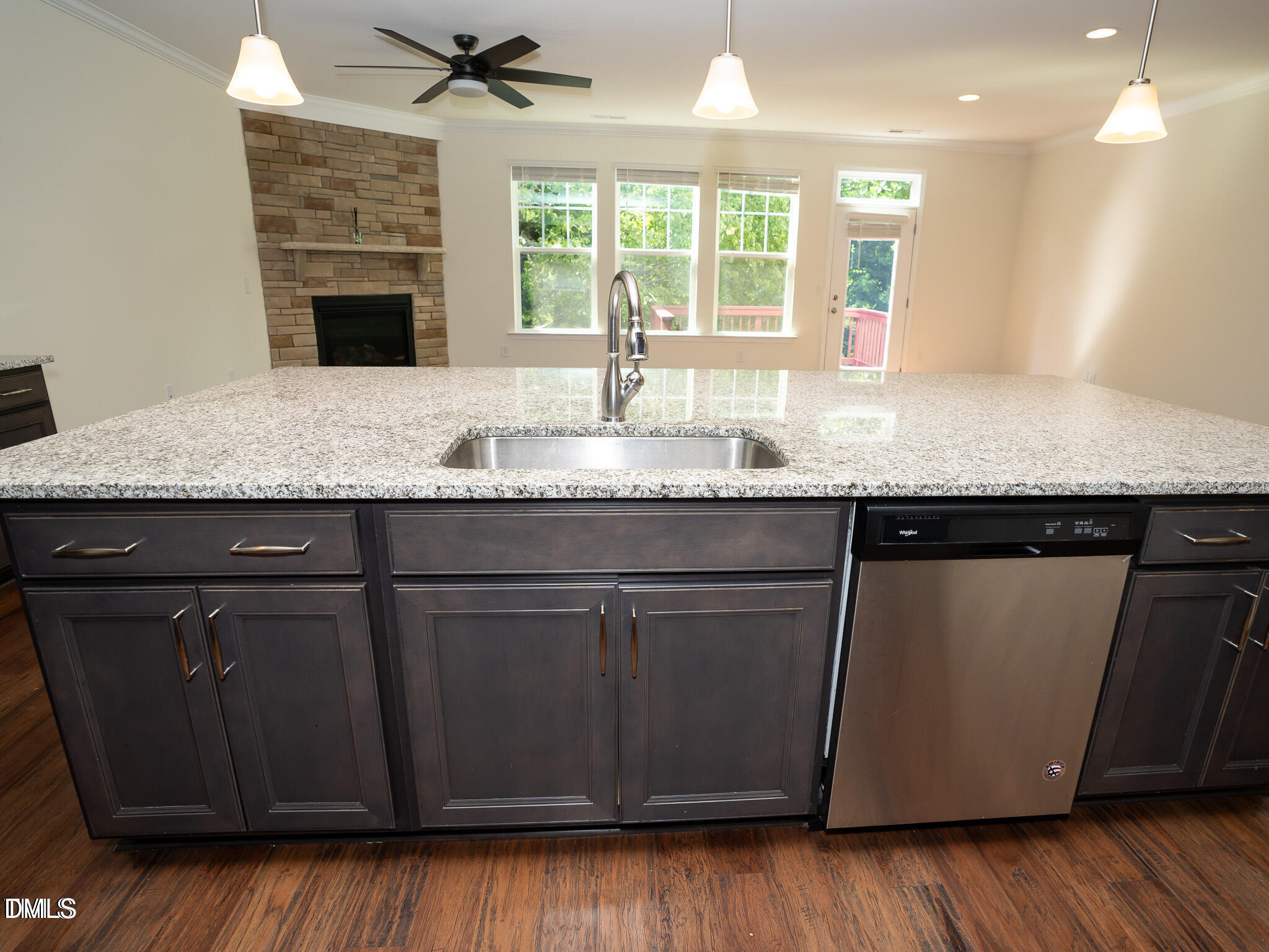 647 Newlyn Drive Raleigh, NC 27606 - Photo 11 of 52 a kitchen with granite countertop a sink a counter space and wooden floor