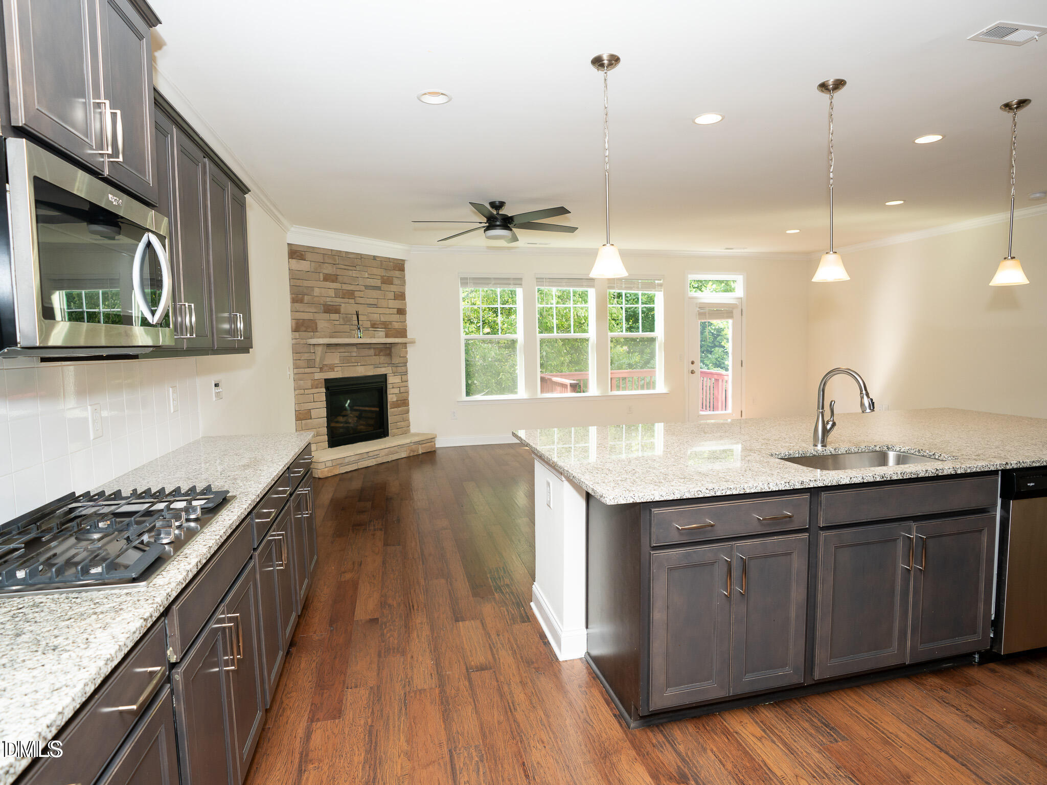647 Newlyn Drive Raleigh, NC 27606 - Photo 14 of 52 a kitchen with a sink stove and cabinets