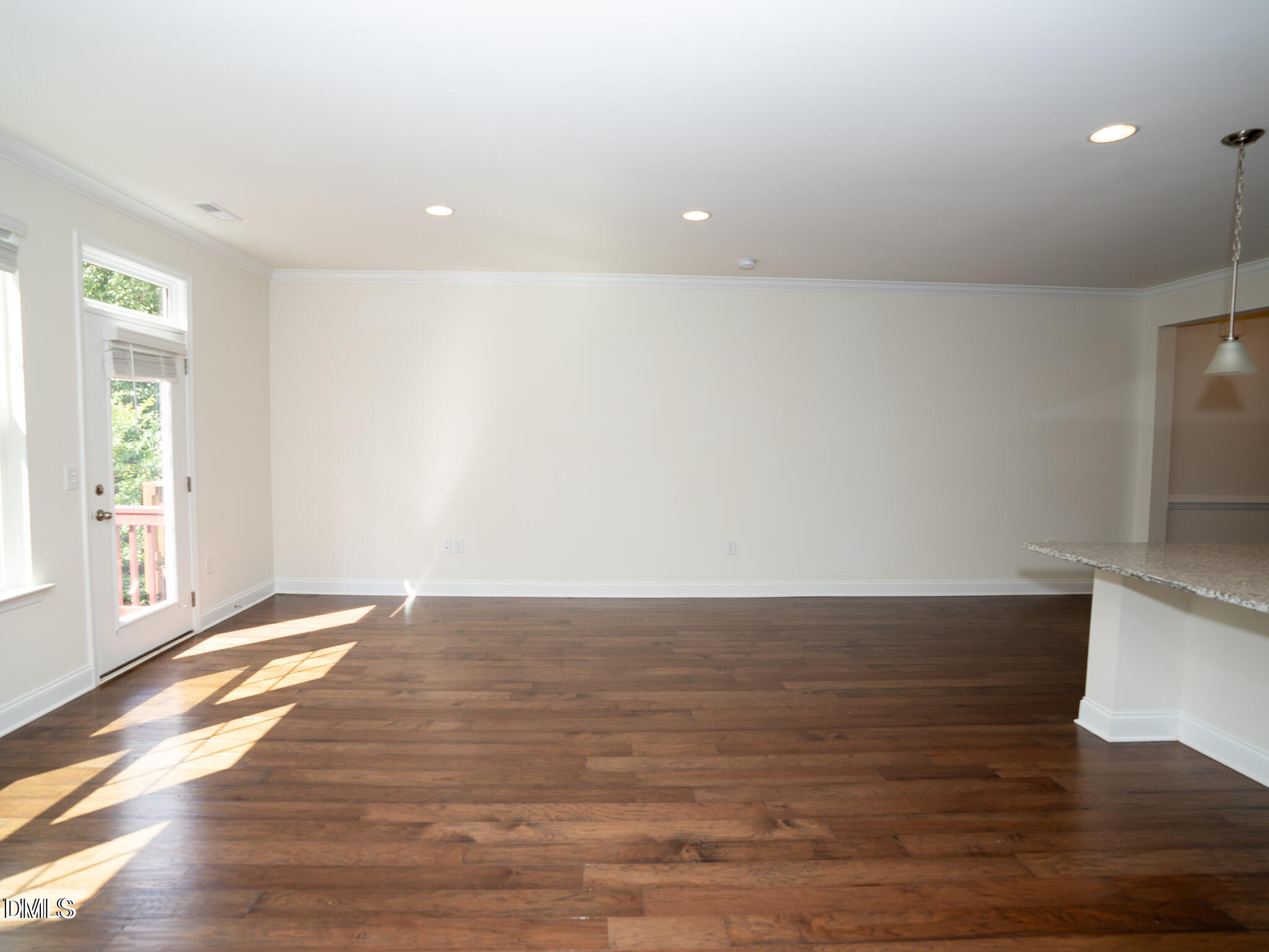 647 Newlyn Drive Raleigh, NC 27606 - Photo 17 of 52 a view of an empty room with wooden floor and a window