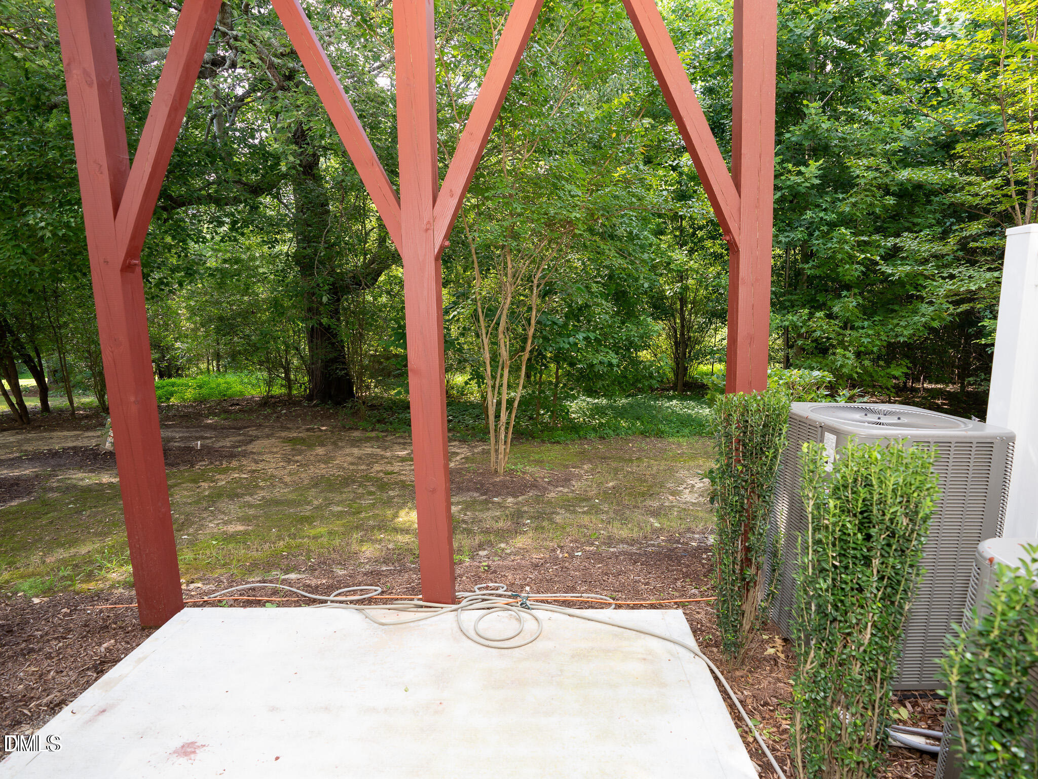 647 Newlyn Drive Raleigh, NC 27606 - Photo 45 of 52 a view of a backyard with plants and a small yard