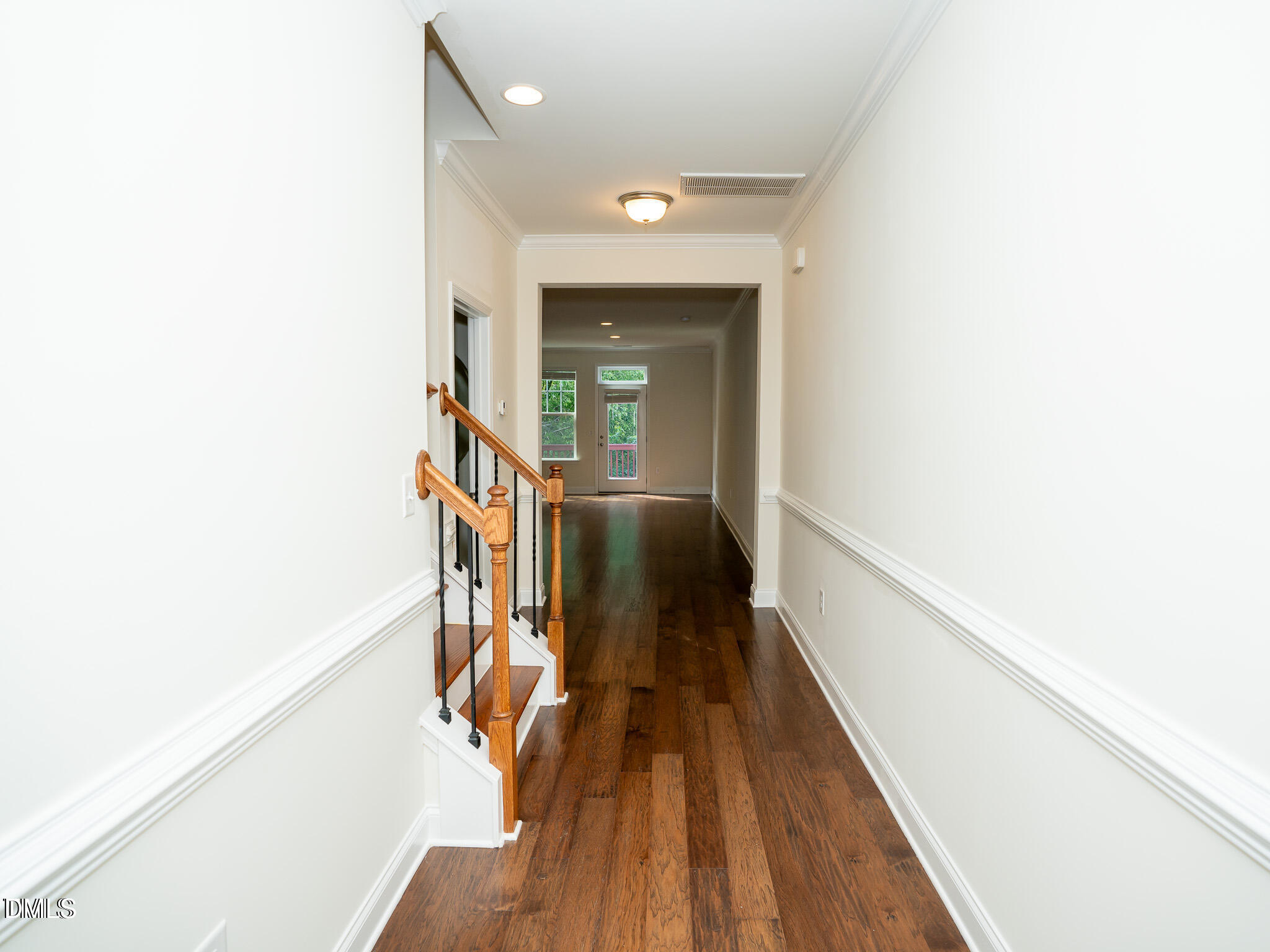 647 Newlyn Drive Raleigh, NC 27606 - Photo 6 of 52 a view of a hallway with wooden floor and staircase