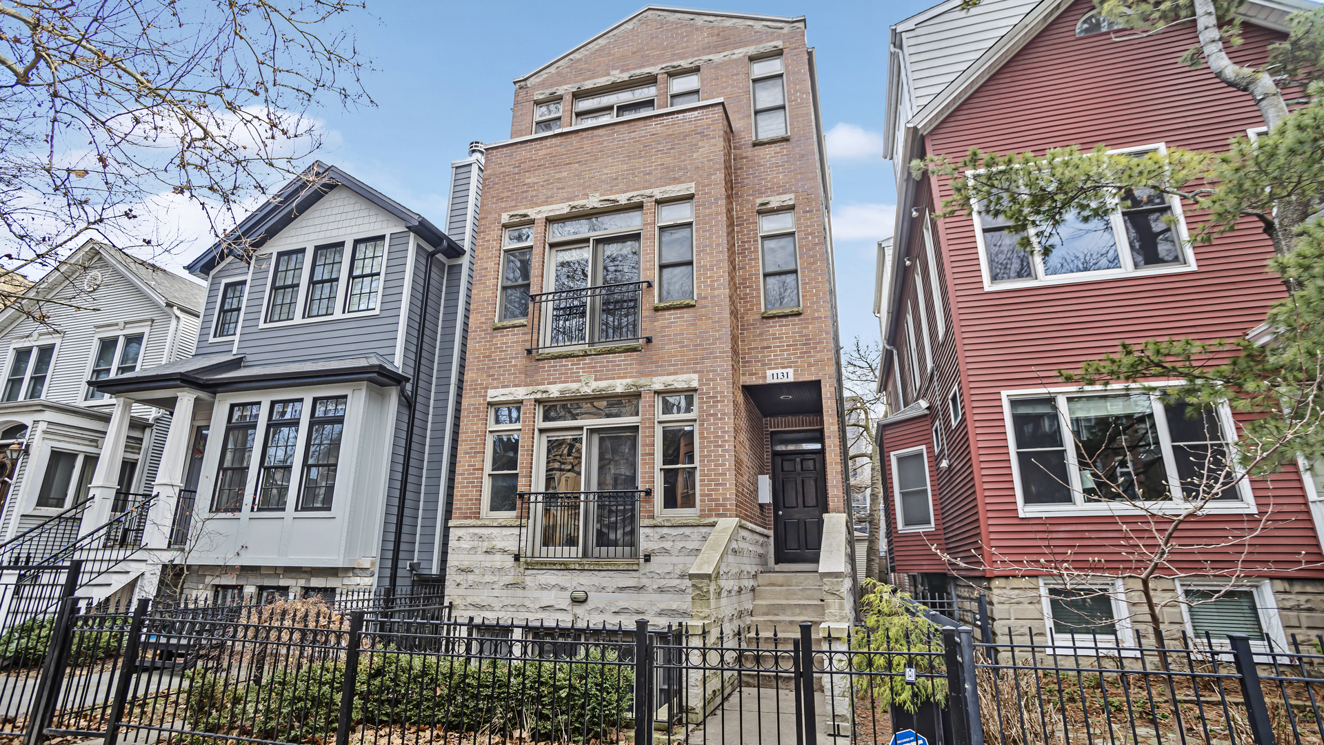 1131 West Wolfram Street, Unit 2 Chicago, IL 60657 - Photo 1 of 15 a view of a brick building next to a yard