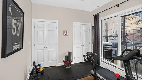 a view of a livingroom with workspace and a window