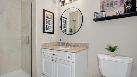 a bathroom with a toilet a sink and a mirror