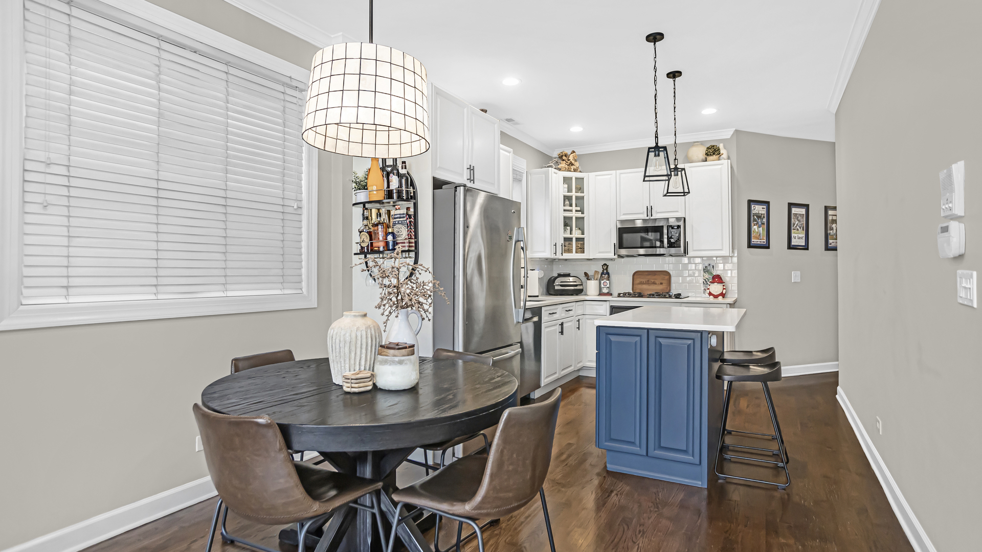 1131 West Wolfram Street, Unit 2 Chicago, IL 60657 - Photo 5 of 15 a kitchen with stainless steel appliances granite countertop a dining table chairs and a refrigerator
