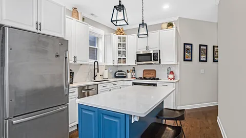 a kitchen with stainless steel appliances a stove refrigerator sink and microwave