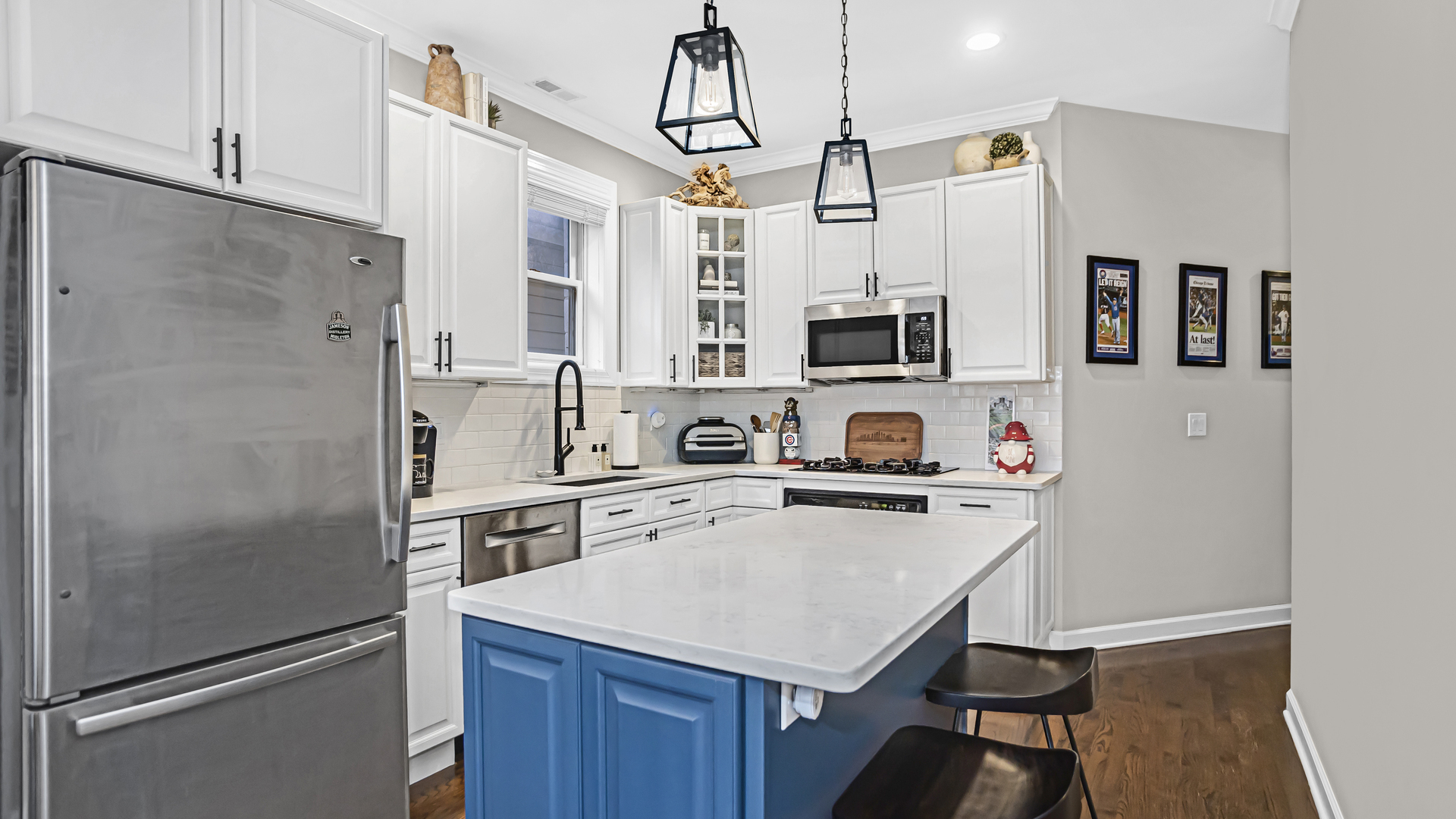 1131 West Wolfram Street, Unit 2 Chicago, IL 60657 - Photo 6 of 15 a kitchen with stainless steel appliances a stove refrigerator sink and microwave