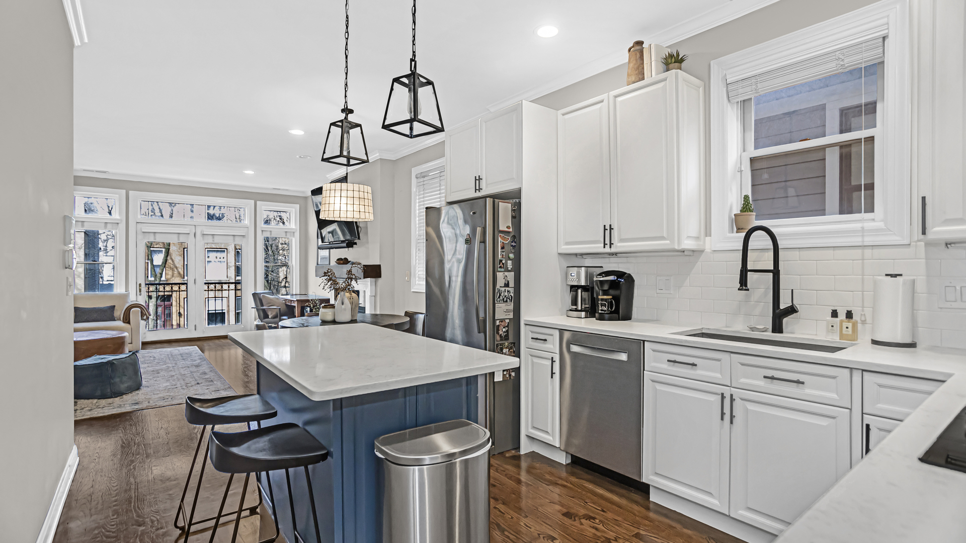 1131 West Wolfram Street, Unit 2 Chicago, IL 60657 - Photo 7 of 15 a kitchen with white cabinets and stainless steel appliances