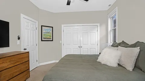 a bedroom with a bed and a window