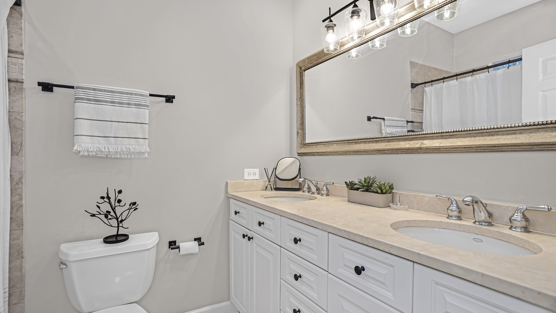1131 West Wolfram Street, Unit 2 Chicago, IL 60657 - Photo 10 of 15 a bathroom with a granite countertop toilet sink and mirror