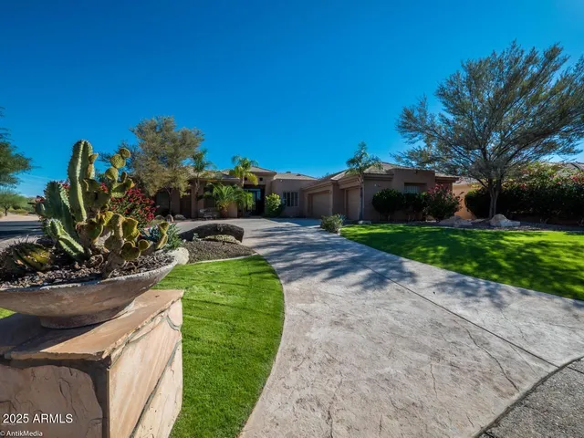 a view of a garden with a house in the background