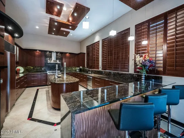 a kitchen with stainless steel appliances granite countertop a stove and a sink
