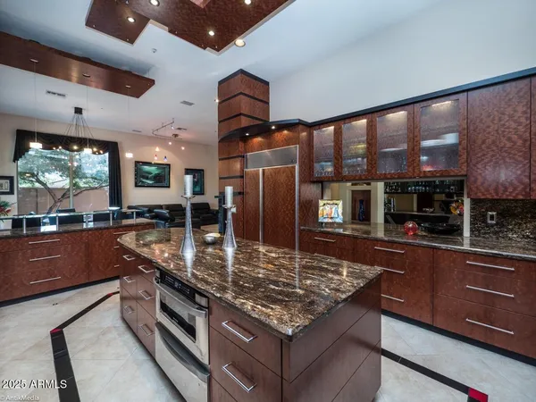 a kitchen with stainless steel appliances granite countertop a stove a sink and a oven