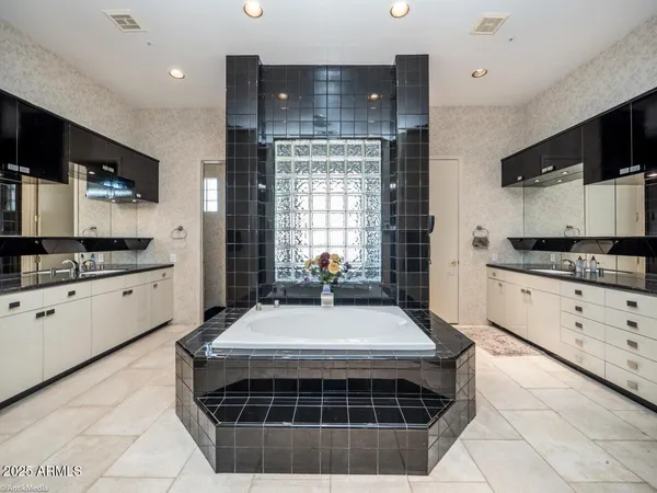 a kitchen with a sink a counter top space and cabinets