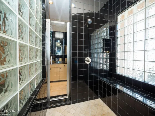 a bathroom with a granite countertop toilet a sink and a mirror