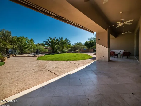 a swimming pool with outdoor seating and yard