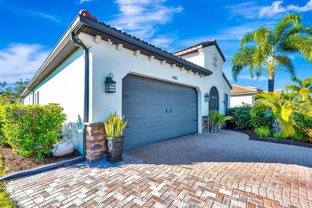 a view of a chair and table in backyard of the house