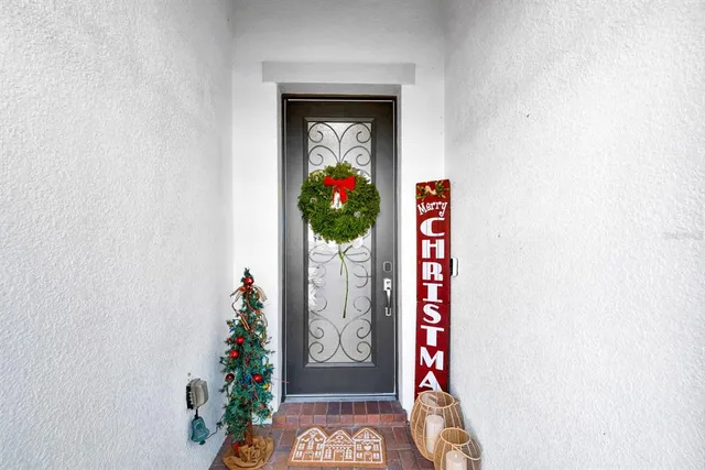 a hallway with painting on the wall and a potted plant