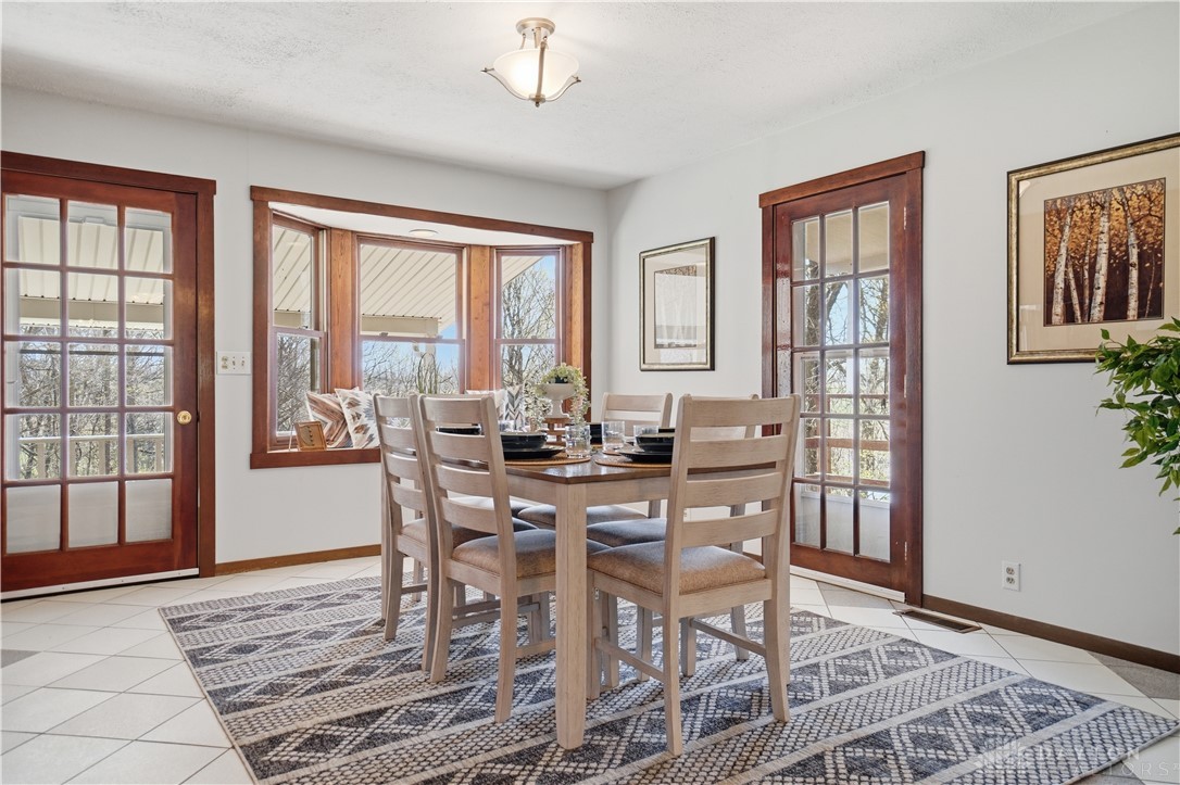 7553 Coffin Station Road Springfield, OH 45502 - Photo 42 of 95 This bright dining area features ample natural light and direct outdoor access, perfect for gatherings.